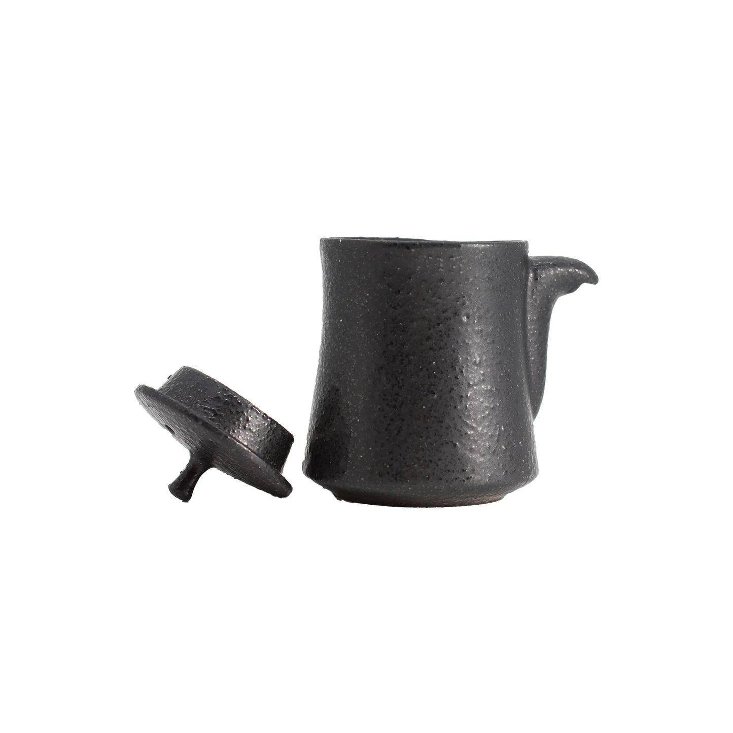 
                  
                    The Soy Sauce Pourer - Black is a small, black ceramic pourer with a textured surface and removable lid, offering a stylish kitchen accessory reminiscent of traditional Japanese design.
                  
                