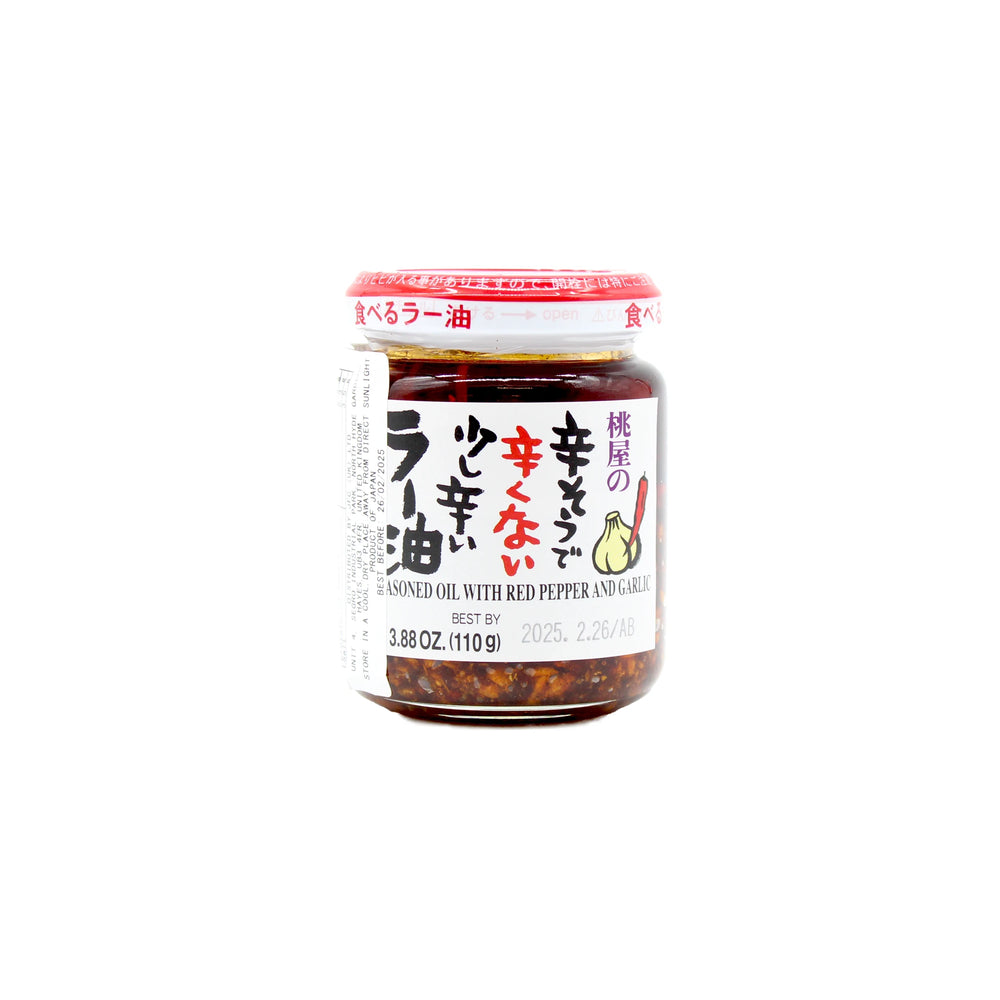 A 110g jar of Momoya Taberu Mild La-Yu Chilli Oil, a Japanese condiment with red pepper and garlic, labeled in Japanese and English, featuring a red lid against a white background.