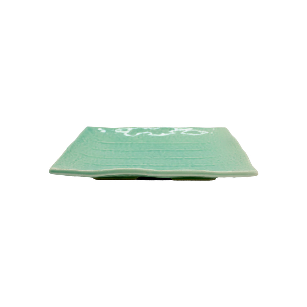 The Sushi Plate - Celadon Green is a rectangular Minoyaki porcelain plate in light green celadon with a subtle textured pattern, shown from the side on a white background.