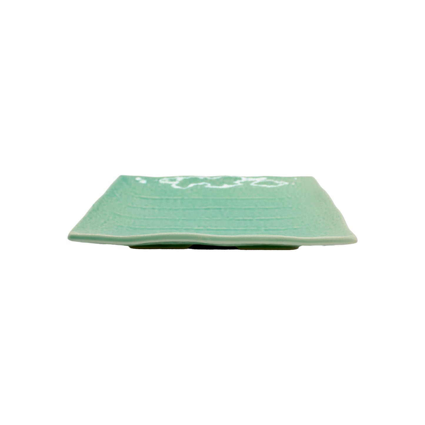
                  
                    The Sushi Plate - Celadon Green is a rectangular Minoyaki porcelain plate in light green celadon with a subtle textured pattern, shown from the side on a white background.
                  
                