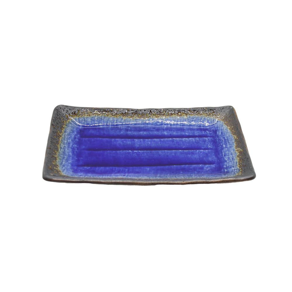 
                  
                    The Sushi Plate - Cobalt Blue Rectangular is a Minoyaki porcelain dish with a vivid blue glazed center and dark, textured edges, exemplifying fine Japanese craftsmanship on a white background.
                  
                