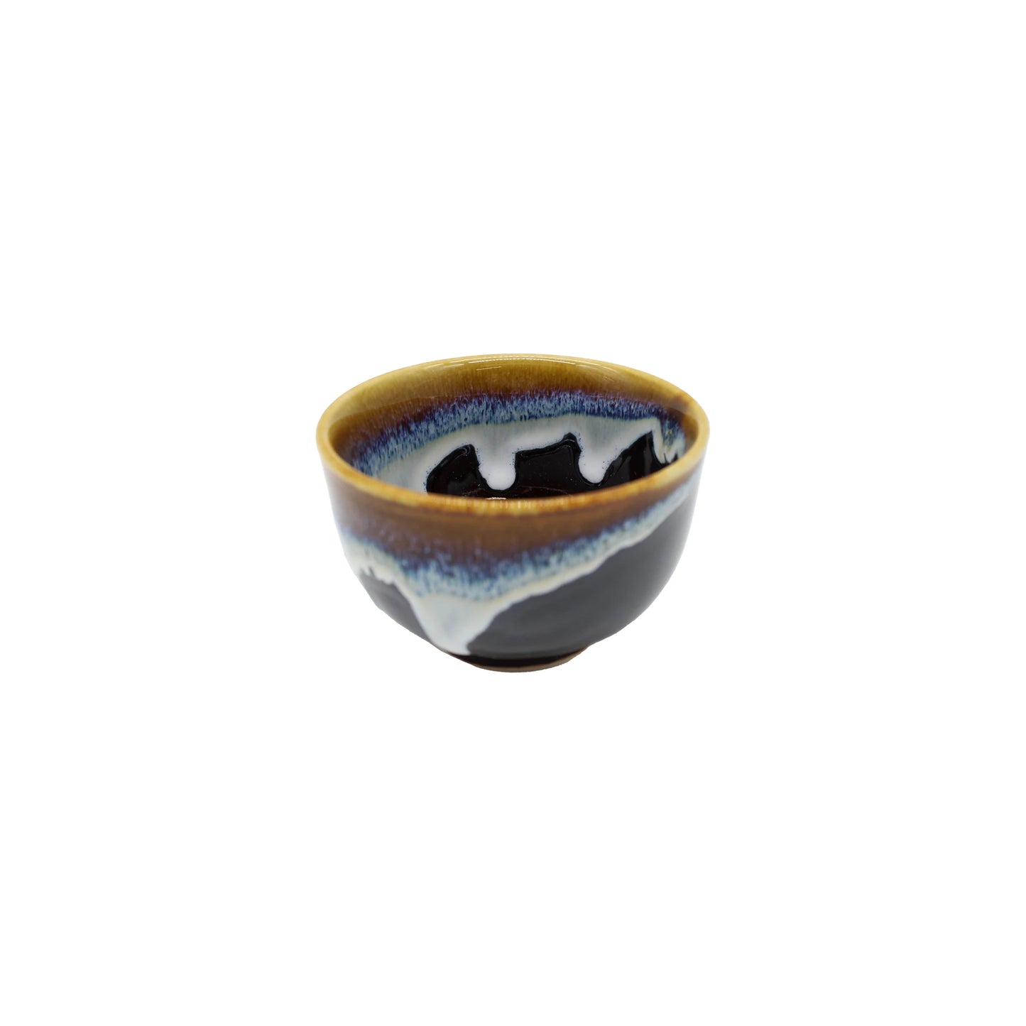 The Tea Cup - Brown with Blue Drip is a Minoyaki porcelain piece with a glossy brown and blue glaze, rounded shape, and smooth finish, shown isolated on a white background.
