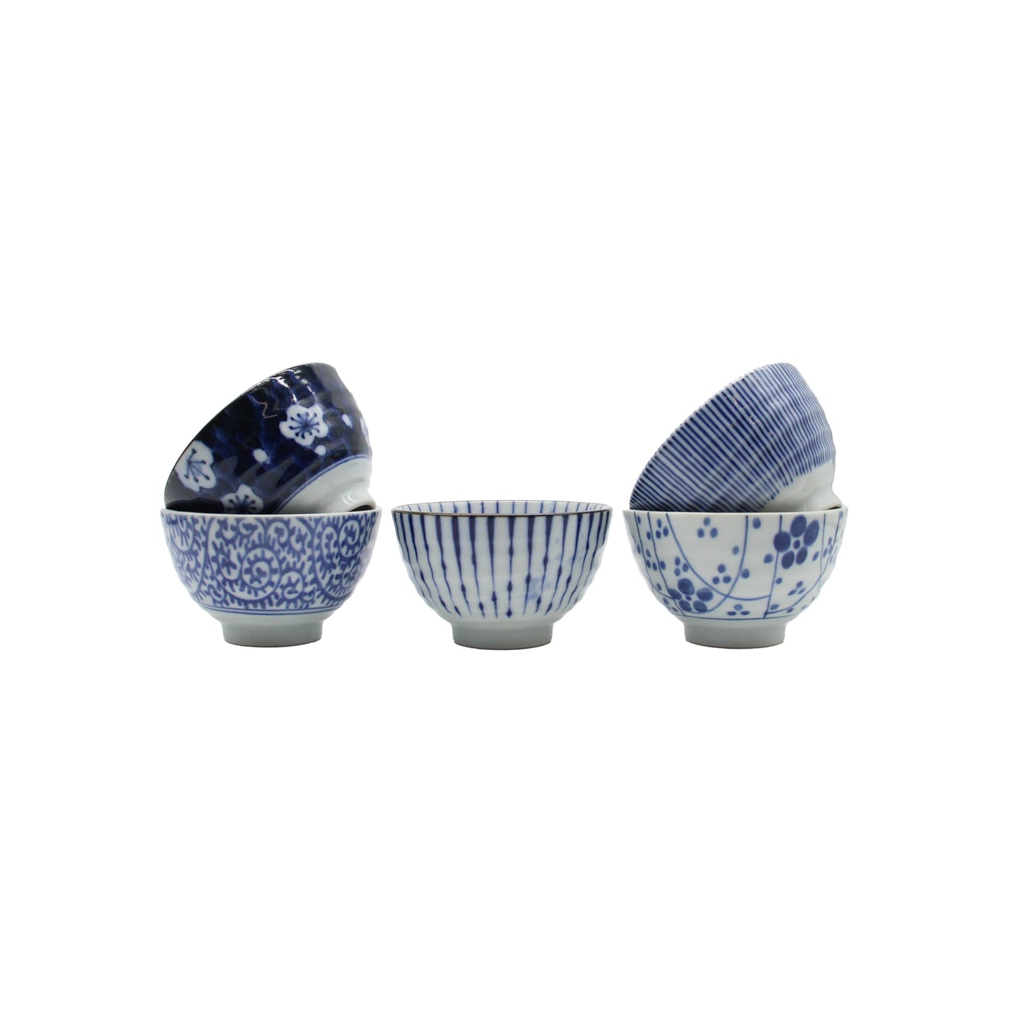 Five small ceramic teacups from the 5 Piece Japanese Teacup Gift Set - Aizome with indigo blue Japanese patterns, arranged in stacks.