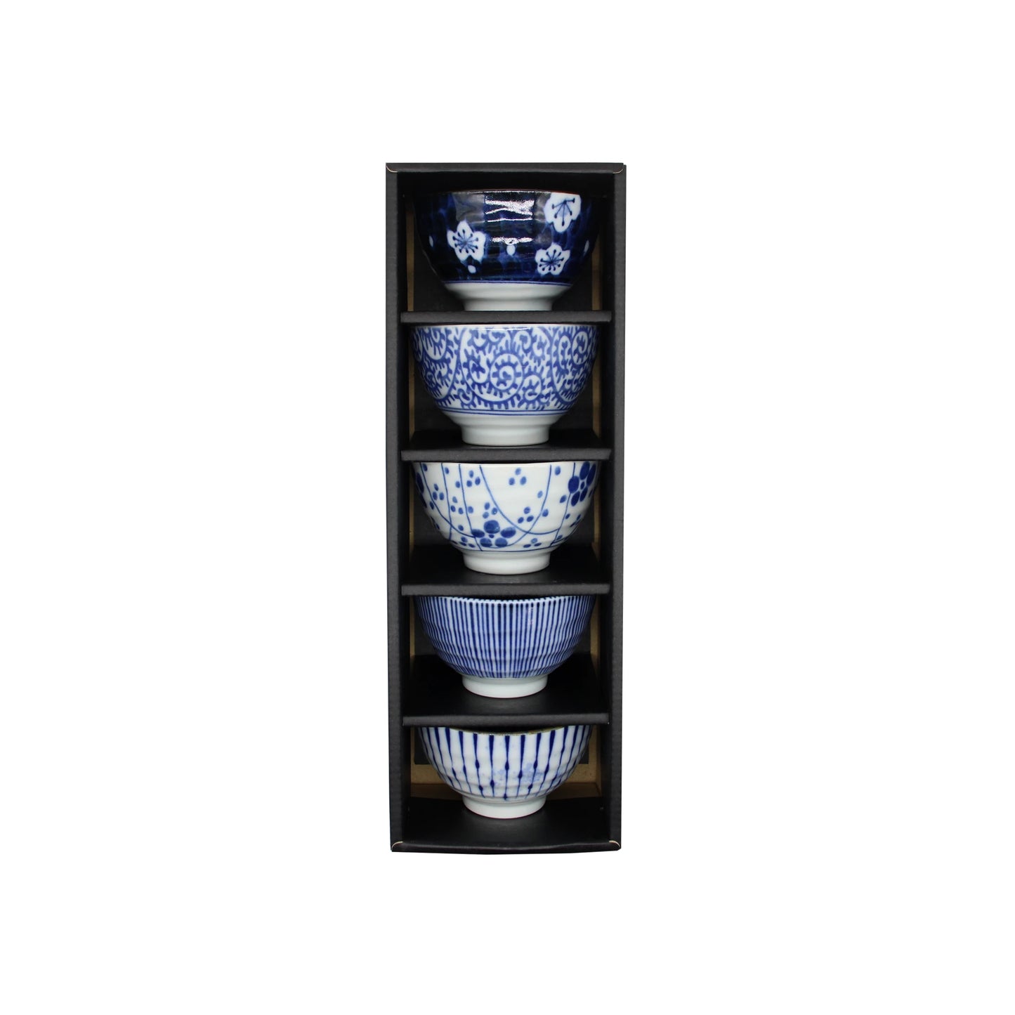 Five ceramic teacups from the 5 Piece Japanese Teacup Gift Set - Aizome with various indigo blue and white patterns, stacked vertically in a tall black gift box.