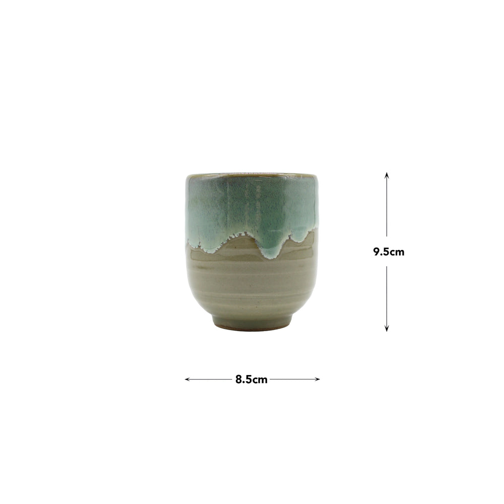 The Tea Mug - Aqua Drip is a Japanese ceramic yunomi teacup with green and beige glaze, showcasing fine craftsmanship. It measures 8.5 cm in diameter and 9.5 cm high, and is displayed against a white background.