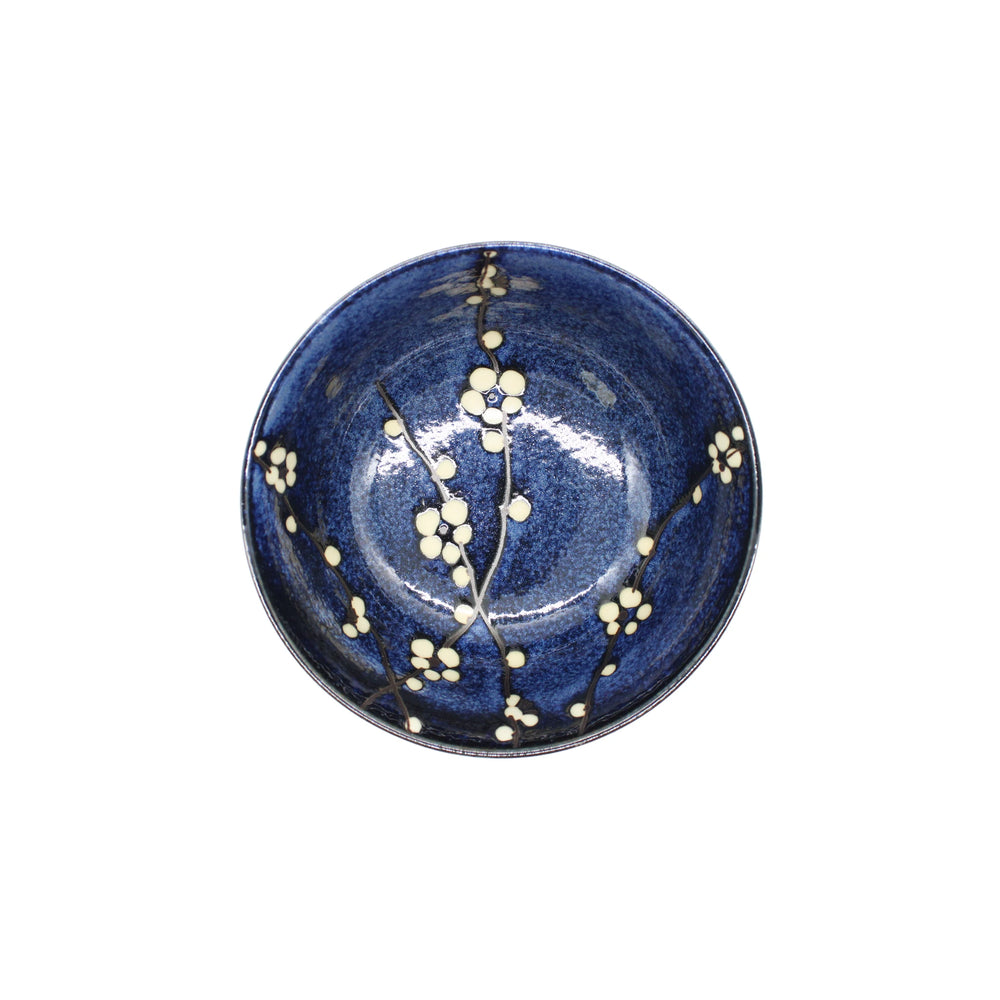The Udon Bowl - Blue Cherry Blossom is a round, blue porcelain bowl with a glossy finish and white cherry blossom design on the interior, shown from above.