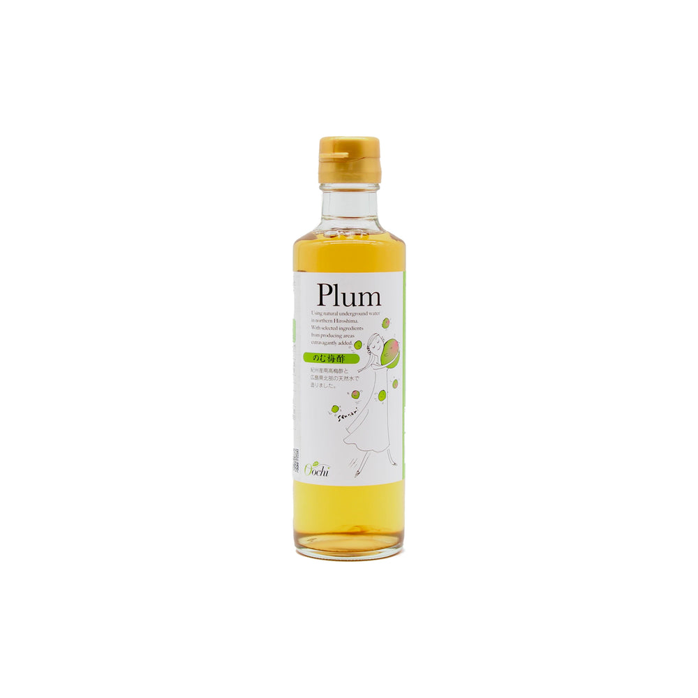 A clear glass bottle with a yellow cap holds yellow liquid labeled Ume Plum Drinking Vinegar, featuring images of plums and a woman—ideal for savoring the unique flavor and health benefits of Japanese ume plum.