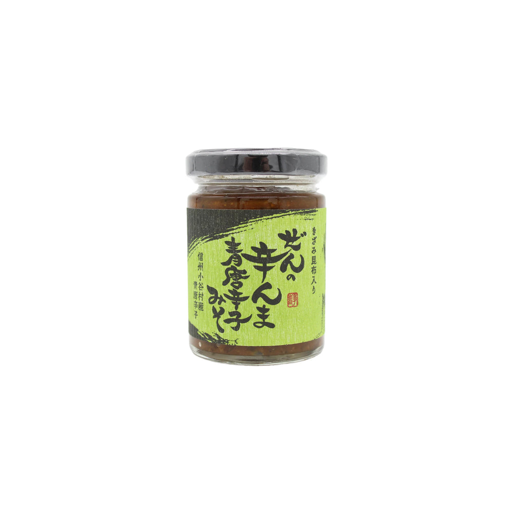 A 120g glass jar of Vegan Zen no Karanma Condiment with a black lid and green Japanese label featuring text and a red stamp. Centered on white, it suggests rich umami flavor from its green pepper miso-inspired contents.