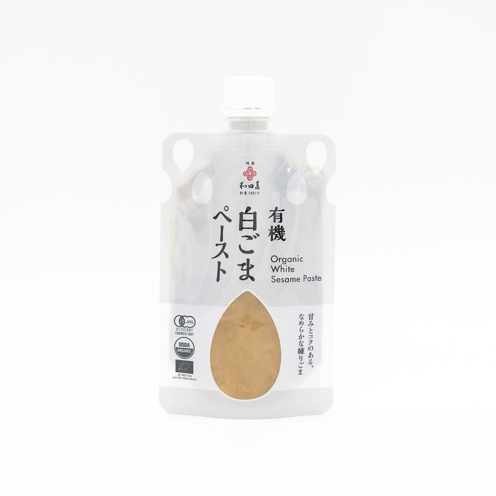 A clear pouch of Wadaman Organic White Sesame Paste with Japanese and English text on the label, a white cap, and USDA Organic certification.