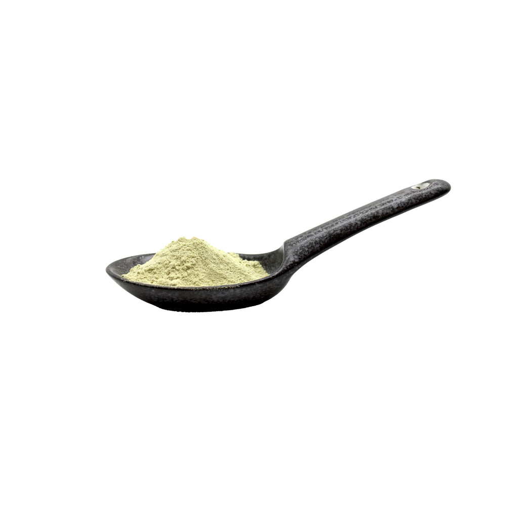 
                  
                    A black ceramic spoon holds a small mound of Wasabi Sea Salt - 45g, a light green powder inspired by Tamaruya and kombu kelp, isolated on a white background.
                  
                
