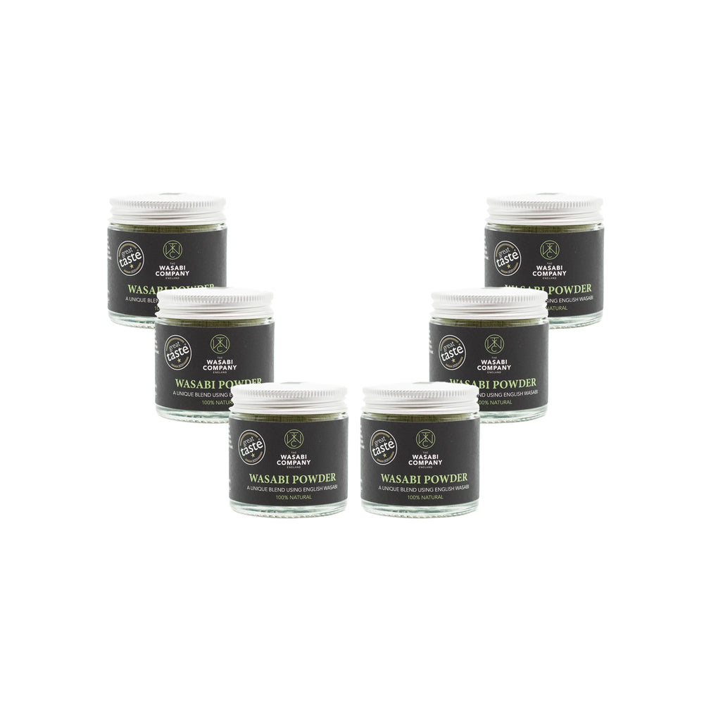 
                  
                    Six 23g jars of Wasabi Powder with white lids and black labels are arranged in a V shape against a plain white background, offering an authentic Japanese spicy flavor.
                  
                