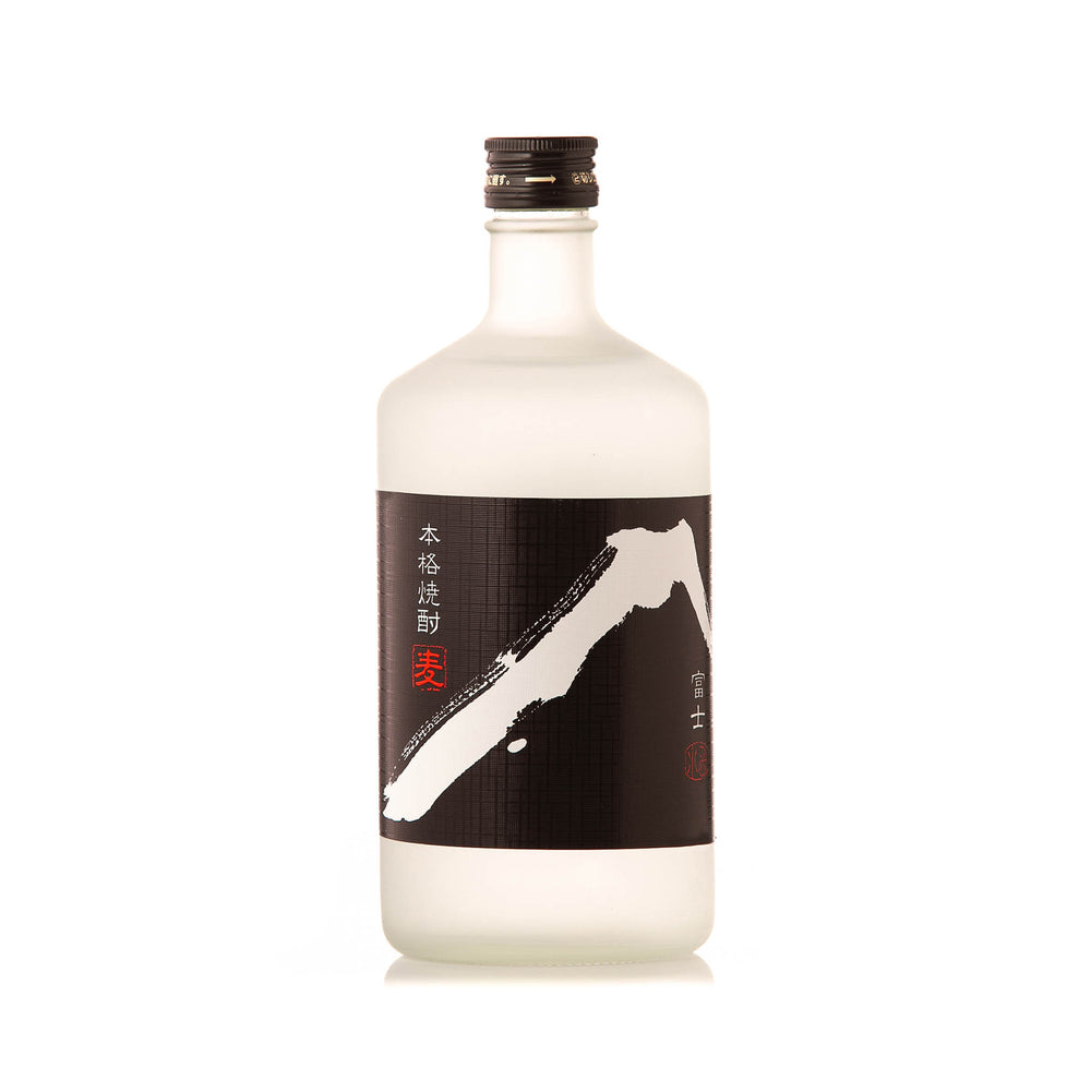 A clear glass bottle of White Fuji Barley Shochu (720ml) with a black label featuring white and red Japanese characters and an abstract design, filled with transparent barley shochu made using pure Mount Rokko water.