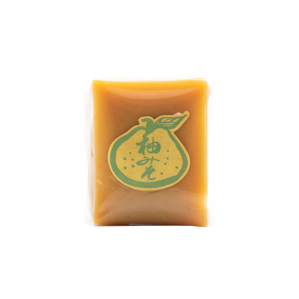 A 500g rectangular block of light brown Yuzu Miso with a green label displaying yuzu citrus artwork and Japanese text, set against a white background.