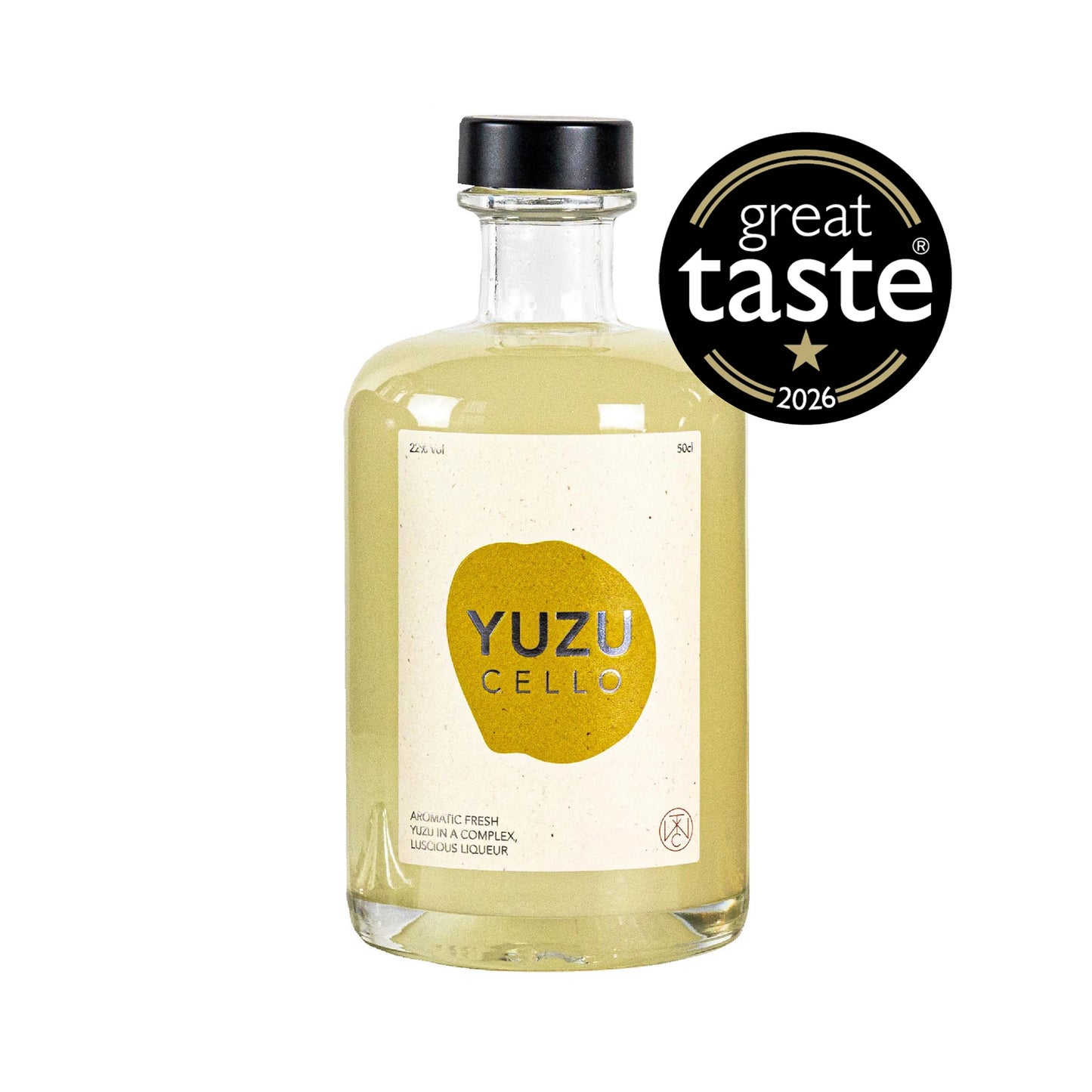 A clear bottle labeled Yuzucello - 50cl, containing a pale yellow citrus liqueur and topped with a black cap; a Great Taste 2026 award badge is featured in the top right corner.
