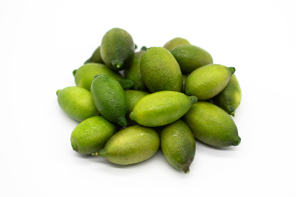 
                  
                    Fresh Finger Limes, Citrus Caviar with green skin are displayed on a white background, highlighting this unique fruit often referred to as lime caviar.
                  
                