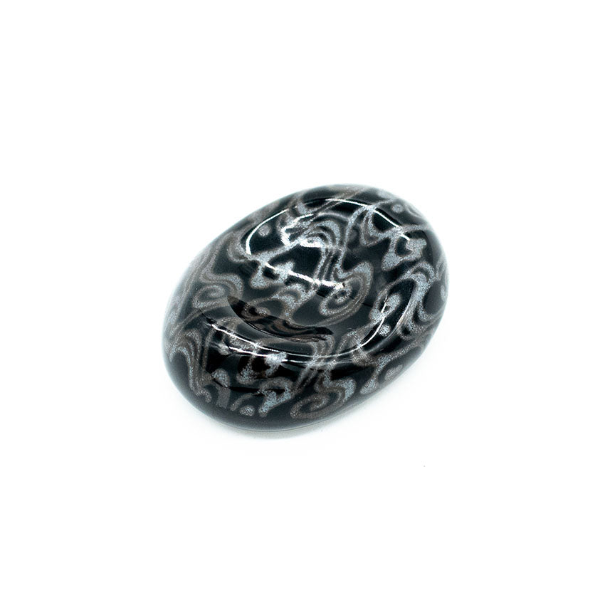 A polished black and gray Minoyaki porcelain stone featuring swirling, abstract water patterns rests on a white background, elegantly serving as the Chopstick Rest - Pebble Shape with Water Swirl.