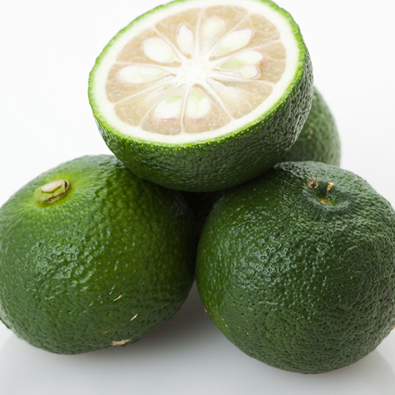 
                  
                    Four Fresh Yuzu fruits are shown—three whole and one halved to reveal the pale, segmented inside. Their green, bumpy skin is similar to other Japanese citrus like kabosu.
                  
                