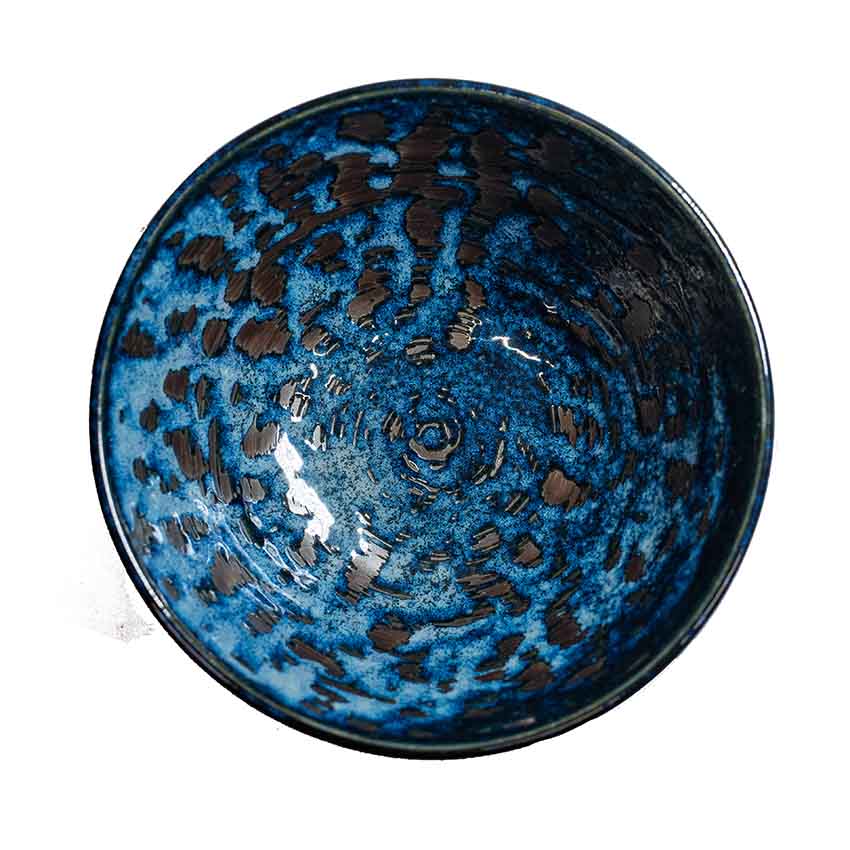 The Udon Bowl - Copper Swirl is a round handmade bowl viewed from above, with a mottled blue and black glaze pattern on the interior, crafted in the Minoyaki porcelain style.