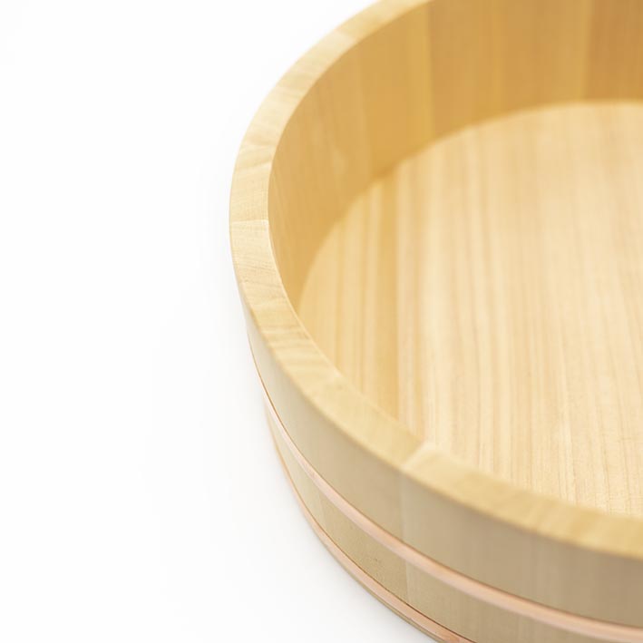 A close-up of the Hangiri Cypress Wood & Copper Rice Bowl, a round, shallow bowl crafted from light Kiso Sawara Cypress wood with smooth sides, displayed against a white background.