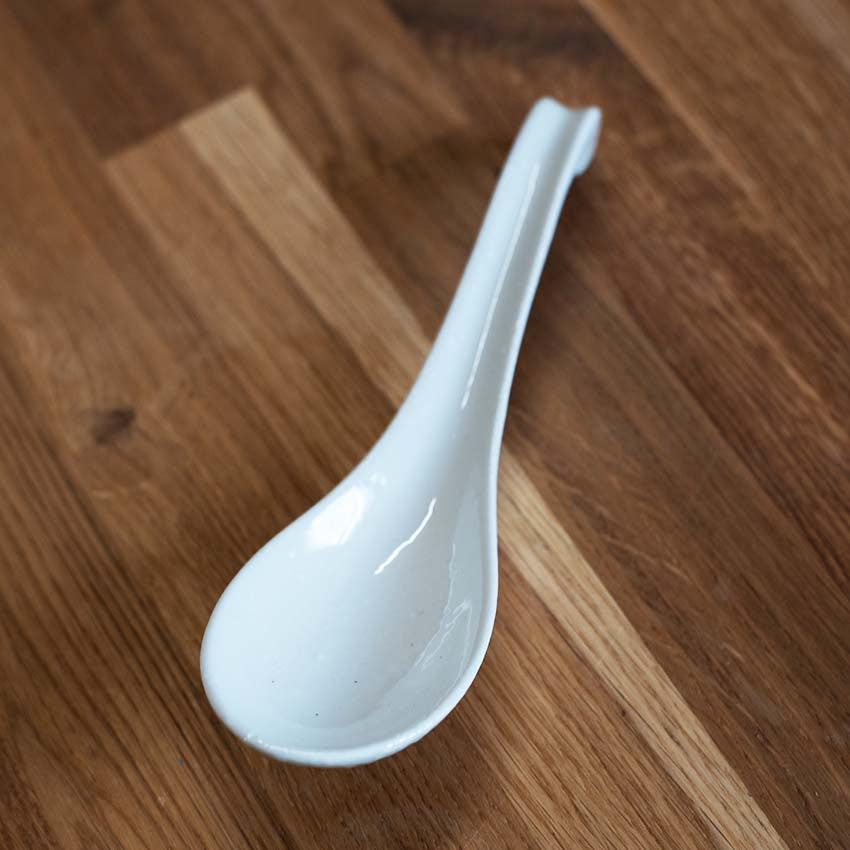 
                  
                    A Spoon - White Gloss rests elegantly on a wooden surface.
                  
                