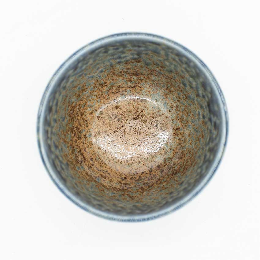 Top view of the Miso Bowl - Earth & Sky, an empty handmade bowl featuring a speckled brown and blue glazed interior, inspired by Japanese ceramics, set against a white background.