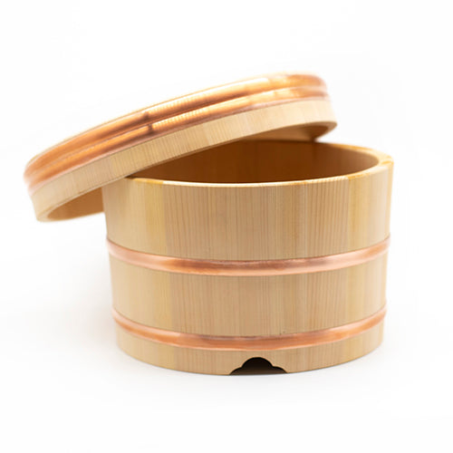 The Ohitsu, Cypress Wood Rice Bowl with Lid, features copper bands and a slightly open lid, displayed against a plain white background.