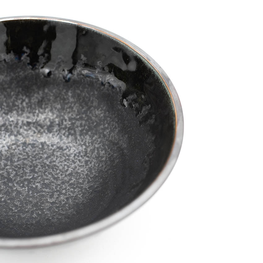 
                  
                    A close-up of the Udon Bowl - Matt Black with Shiny Edge, featuring a handmade ceramic design and glossy speckled interior, set against a white background.
                  
                