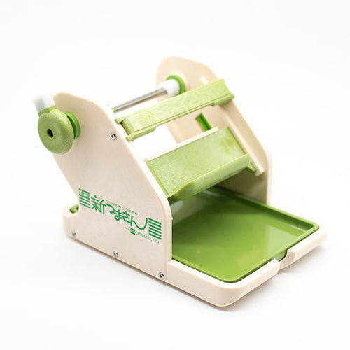 The Vegetable & Fruit Cutter is a green and beige manual slicer with a crank and tray, ideal for slicing or pressing food. Japanese text appears on the side.