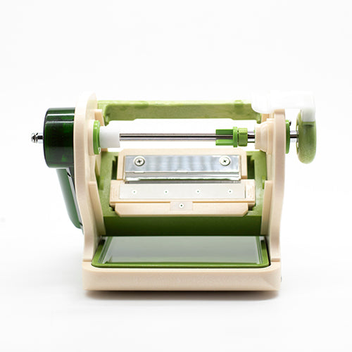The Vegetable & Fruit Cutter is a green and white manual slicer and spiralizer with a handle, blade, and tray, shown against a plain white background.