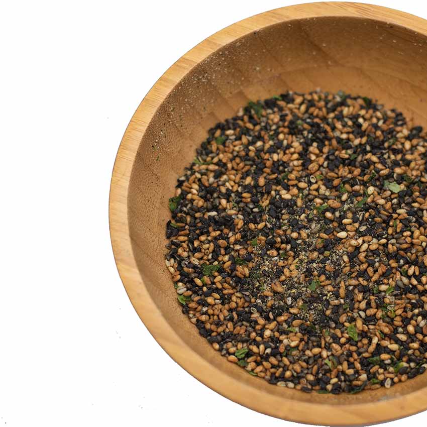 
                  
                    A wooden bowl holds Wadaman Furikake Sesame & Sansho Pepper 30g, featuring black and white sesame seeds with green sansho pepper flakes.
                  
                